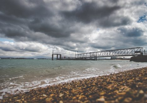 View of the Hayling Ferry from the Eastney Beach, with a rising tide and a cloudy sky